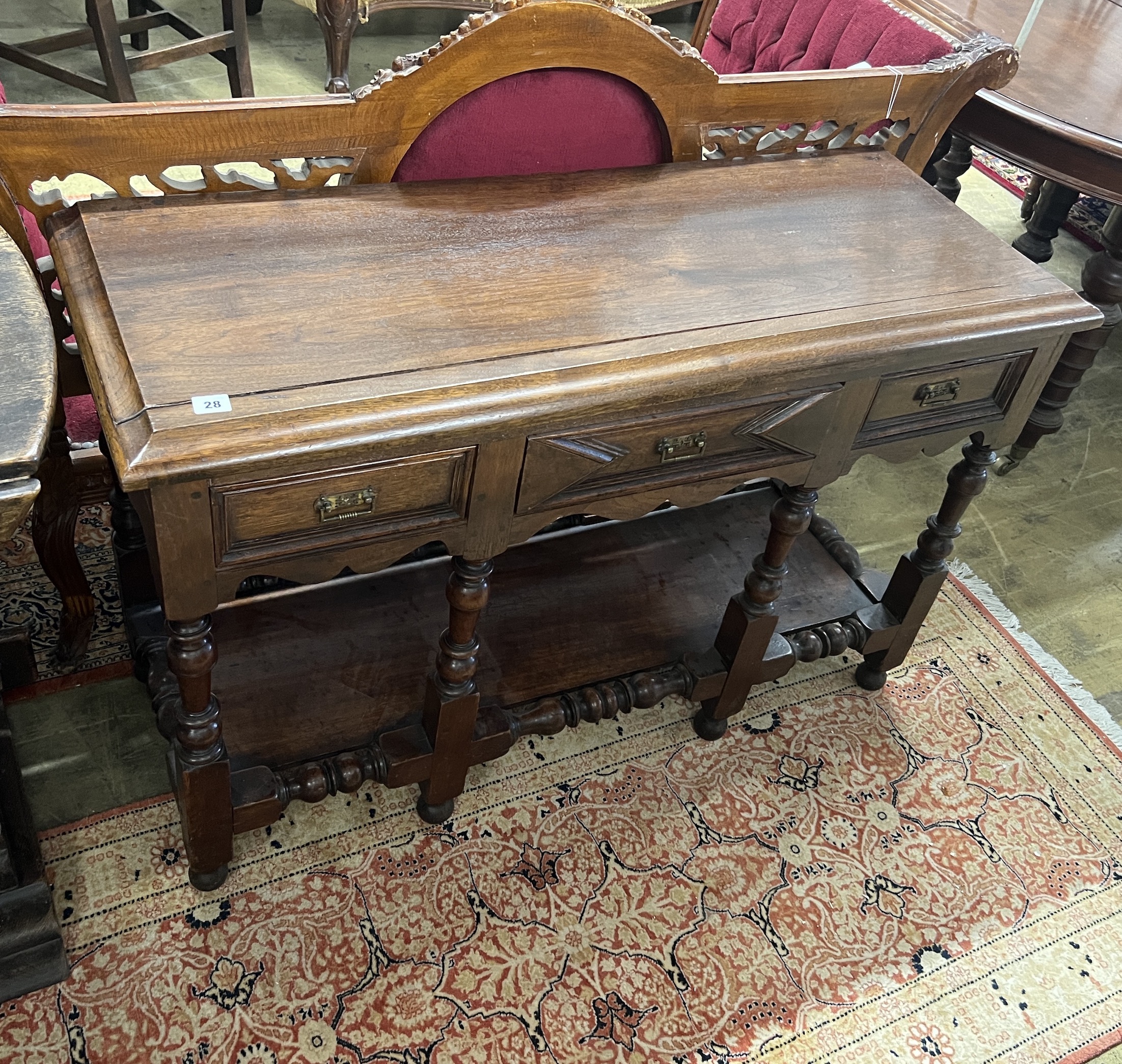 A small Jacobean revival oak low potboard dresser, width 116cm, depth 43cm, height 73cm